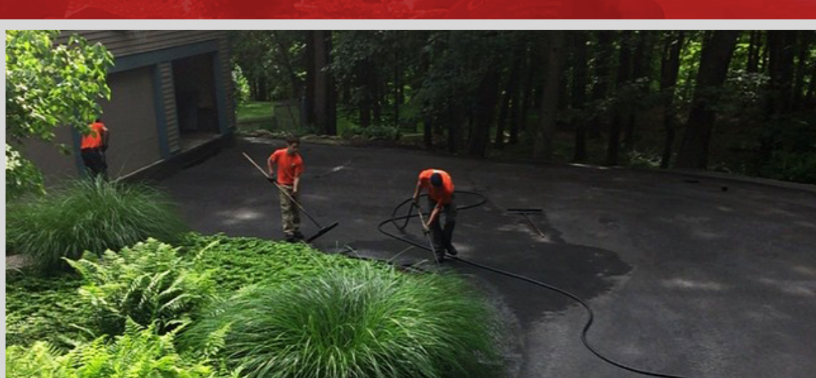 CSI crew sealcoating a wooded residential driveway